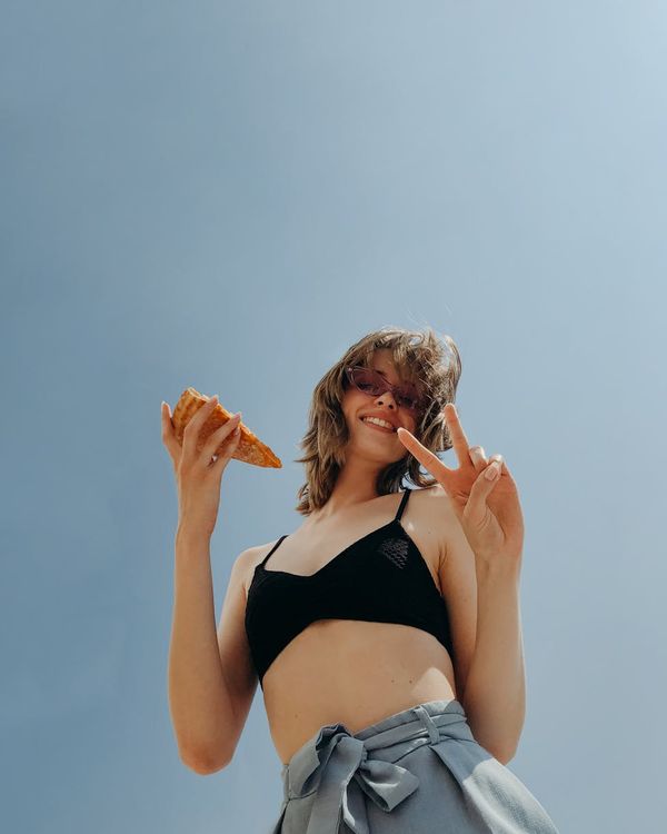 Woman feeling energetic and happy outdoors in the sun.